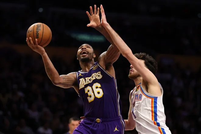 Feb 9, 2026; Los Angeles, California, USA; Los Angeles Lakers guard Marcus Smart (36) shoots the ball against Oklahoma City Thunder center Chet Holmgren (7) during the fourth quarter at Crypto.com Arena.