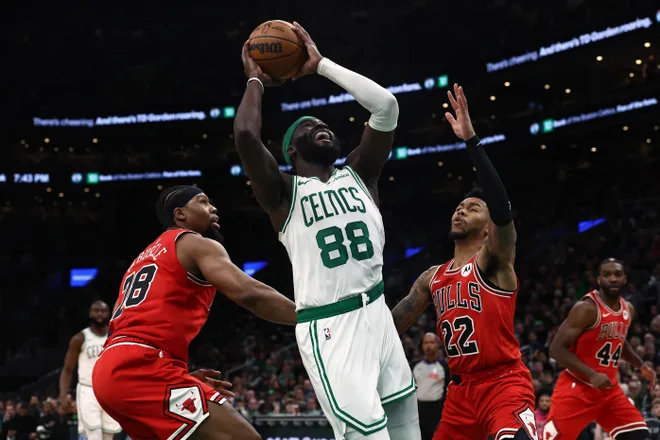 Feb 11, 2026; Boston, Massachusetts, USA; Boston Celtics center Neemias Queta (88) goes between Chicago Bulls guard Anfernee Simons (22) and forward Guerschon Yabusele (28) during the first quarter at TD Garden. Mandatory Credit: Winslow Townson-Imagn Images