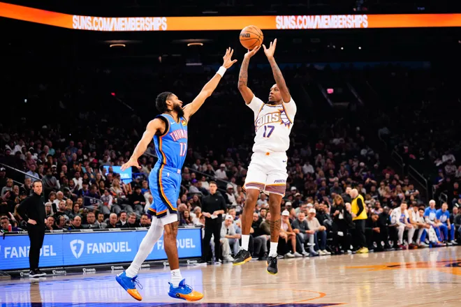 Feb 11, 2026; Phoenix, Arizona, USA; Phoenix Suns guard Jamaree Bouyea (17) shoots over Oklahoma City Thunder guard Isaiah Joe (11) during the first half of the game at Mortgage Matchup Center. Mandatory Credit: Arianna Grainey-Imagn Images