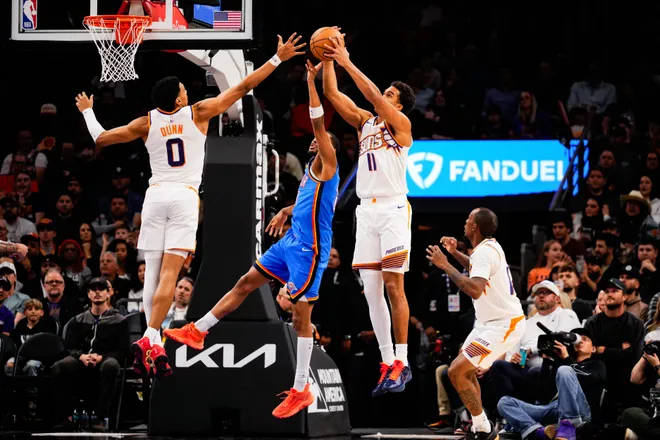 Feb 11, 2026; Phoenix, Arizona, USA; Phoenix Suns forward Oso Ighodaro (11) rebounds the ball during the second half of the game at Mortgage Matchup Center. Mandatory Credit: Arianna Grainey-Imagn Images