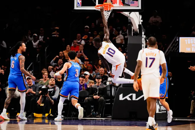 Feb 11, 2026; Phoenix, Arizona, USA; Phoenix Suns center Khaman Maluach (10) hangs on the rim during the second half of the game at Mortgage Matchup Center. Mandatory Credit: Arianna Grainey-Imagn Images