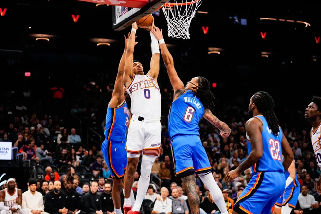 Feb 11, 2026; Phoenix, Arizona, USA;Phoenix Suns forward Ryan Dunn (0) attempts a shot against Oklahoma City Thunder forward Jaylin Williams (6) during the first half of the game at Mortgage Matchup Center. Mandatory Credit: Arianna Grainey-Imagn Images