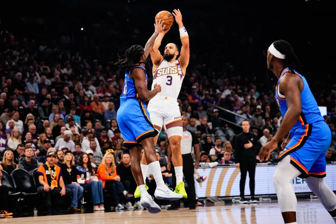 Feb 11, 2026; Phoenix, Arizona, USA; Phoenix Suns guard/forward Dillon Brooks (3) shoots against Oklahoma City Thunder guard Cason Wallace (22)during the first half of the game at Mortgage Matchup Center. Mandatory Credit: Arianna Grainey-Imagn Images