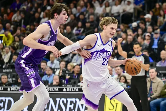 Feb 11, 2026; Salt Lake City, Utah, USA; Utah Jazz forward/center Lauri Markkanen (23) drives into the basket around Sacramento Kings center Maxime Raynaud (42) during the second half at Delta Center.