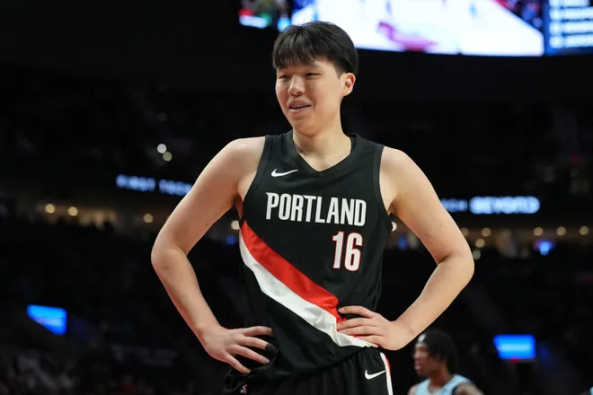 Feb 7, 2026; Portland, Oregon, USA; Portland Trail Blazers center Yang Hansen (16) reacts to a call during the first half against the Memphis Grizzlies at Moda Center. Mandatory Credit: Soobum Im-Imagn Images