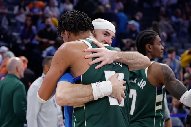 Feb 12, 2026; Oklahoma City, Oklahoma, USA; Oklahoma City Thunder guard Alex Caruso (9) hugs former teammate Milwaukee Bucks forward Ousmane Dieng (21) at the end of their game at Paycom Center. Mandatory Credit: Alonzo Adams-Imagn Images