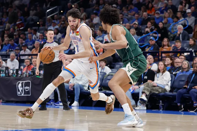 Feb 12, 2026; Oklahoma City, Oklahoma, USA; Oklahoma City Thunder center/forward Chet Holmgren (7) drives around Milwaukee Bucks center Jericho Sims (00) during the second half at Paycom Center. Mandatory Credit: Alonzo Adams-Imagn Images