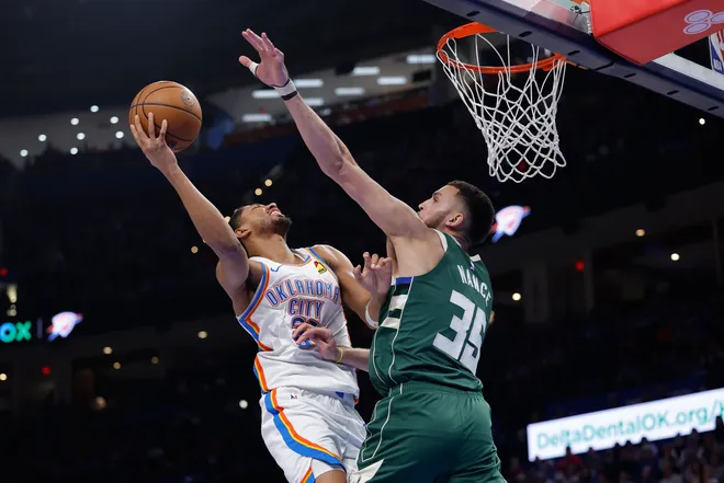 Feb 12, 2026; Oklahoma City, Oklahoma, USA; Oklahoma City Thunder guard Aaron Wiggins (21) shoots as Milwaukee Bucks forward Pete Nance (35) defends during the second half at Paycom Center. Mandatory Credit: Alonzo Adams-Imagn Images
