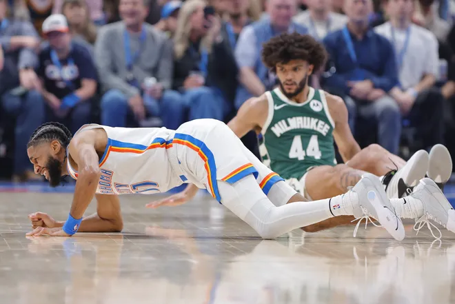 Feb 12, 2026; Oklahoma City, Oklahoma, USA; Oklahoma City Thunder guard Isaiah Joe (11) and Milwaukee Bucks guard Andre Jackson Jr. (44) fall to the floor during the first half at Paycom Center. Mandatory Credit: Alonzo Adams-Imagn Images
