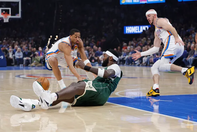 Feb 12, 2026; Oklahoma City, Oklahoma, USA; Milwaukee Bucks forward Bobby Portis (9) and Oklahoma City Thunder guard Aaron Wiggins (21) reach for a loose ball during the first half at Paycom Center. Mandatory Credit: Alonzo Adams-Imagn Images