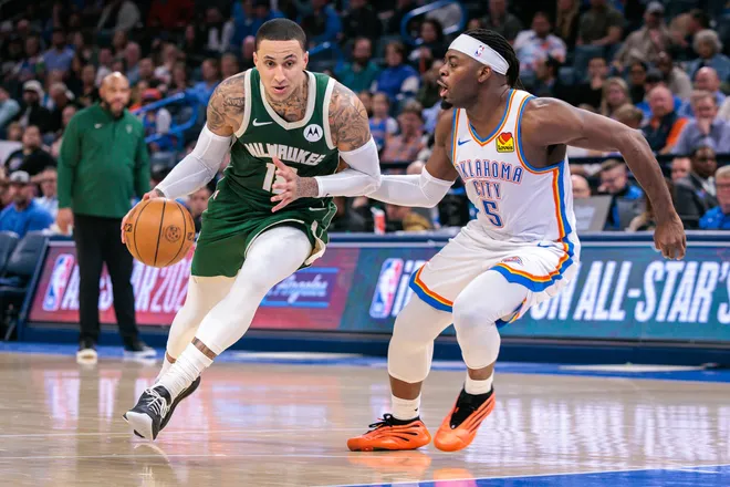 OKLAHOMA CITY, OKLAHOMA - FEBRUARY 12: Kyle Kuzma #18 of the Milwaukee Bucks drives to the basket around Luguentz Dort #5 of the Oklahoma City Thunder during the second half at Paycom Center on February 12, 2026 in Oklahoma City, Oklahoma. NOTE TO USER: User expressly acknowledges and agrees that, by downloading and or using this photograph, User is consenting to the terms and conditions of the Getty Images License Agreement. (Photo by William Purnell/Getty Images)
