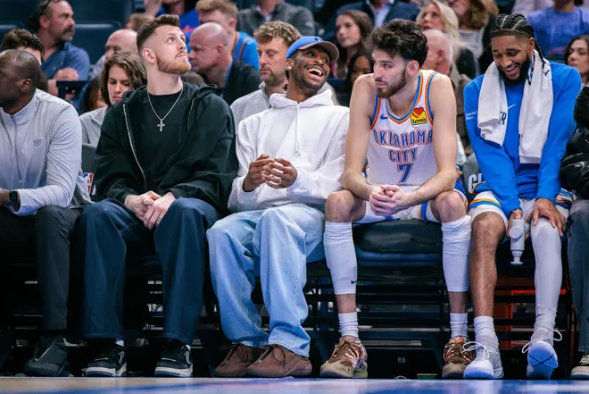 OKLAHOMA CITY, OKLAHOMA - FEBRUARY 12: (L-R) Isaiah Hartenstein #55, Shai Gilgeous-Alexander #2 and Chet Holmgren #7 of the Oklahoma City Thunder sit on the bench during the first half against the Milwaukee Bucks at Paycom Center on February 12, 2026 in Oklahoma City, Oklahoma. NOTE TO USER: User expressly acknowledges and agrees that, by downloading and or using this photograph, User is consenting to the terms and conditions of the Getty Images License Agreement. (Photo by William Purnell/Getty Images)