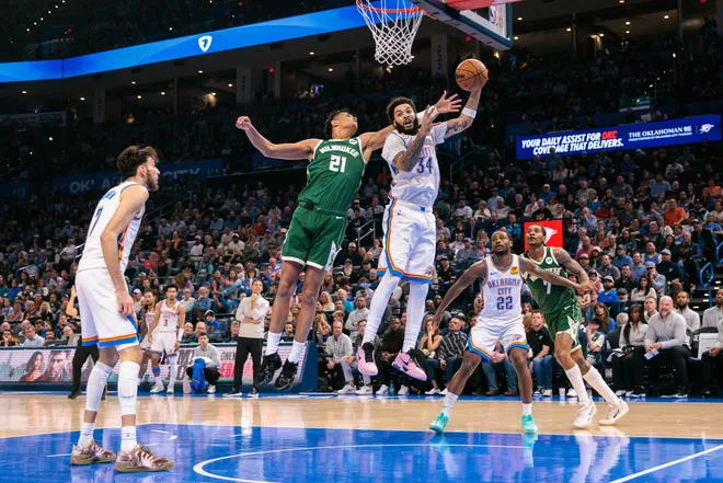 OKLAHOMA CITY, OKLAHOMA - FEBRUARY 12: Kenrich Williams #34 of the Oklahoma City Thunder and Ousmane Dieng #21 of the Milwaukee Bucks reach for a rebound during the second half at Paycom Center on February 12, 2026 in Oklahoma City, Oklahoma. NOTE TO USER: User expressly acknowledges and agrees that, by downloading and or using this photograph, User is consenting to the terms and conditions of the Getty Images License Agreement. (Photo by William Purnell/Getty Images)