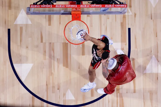 INGLEWOOD, CALIFORNIA - FEBRUARY 14: (EDITORS NOTE: Image Has Been Taken Using A Static Remote Camera.) Keshad Johnson #16 of the Miami Heat jumps over E-40 during the AT&T Slam Dunk Contest during 2026 NBA All-Star Weekend at Intuit Dome on February 14, 2026 in Inglewood, California. NOTE TO USER: User expressly acknowledges and agrees that, by downloading and or using this photograph, User is consenting to the terms and conditions of the GettyImages License Agreement. (Photo by Ronald Martinez/Getty Images)
