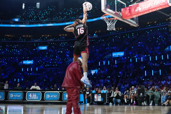 Feb 14, 2026; Los Angeles, CA, USA; Miami Heat forward Keshad Johnson (16) dunks over rapper E-40 in the slam dunk contest during the 2026 NBA All Star Saturday Night at Intuit Dome. Mandatory Credit: Kirby Lee-Imagn Images