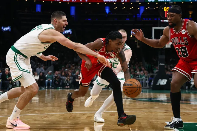 Feb 11, 2026; Boston, Massachusetts, USA; Chicago Bulls Rob Dillingham (7) goes past Boston Celtics center Nikola Vucevic (4) during the second half at TD Garden. Mandatory Credit: Winslow Townson-Imagn Images
