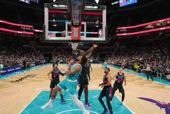 Feb 9, 2026; Charlotte, North Carolina, USA; Charlotte Hornets forward Miles Bridges (0) and Detroit Pistons center Jalen Duren (0) collide at the rim during the second half at Spectrum Center. Mandatory Credit: Jim Dedmon-Imagn Images