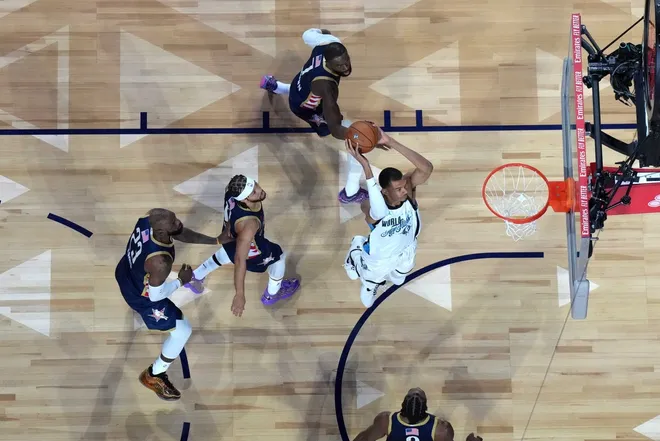 Feb 15, 2026; Inglewood, California, USA; Team World center Victor Wembanyama (1) of the San Antonio Spurs dunks the ball against Team USA Stripes forward LeBron James (23) of the Los Angeles Lakers, Kawhi Leonard (2) of the LA Clippers, guard Jalen Brunson (11) of the New York Knicks and Jaylen Brown (7) of the Boston Celtics during the 75th NBA All Star Game at Intuit Dome.