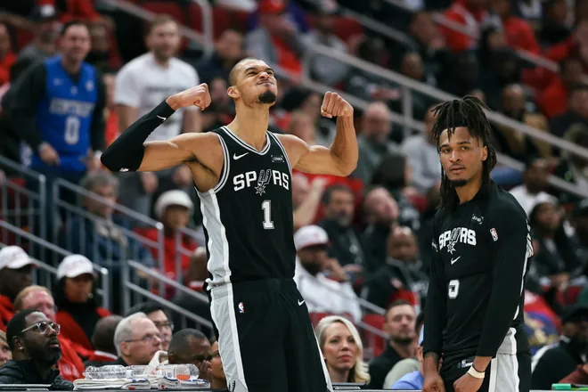 Jan 28, 2026; Houston, Texas, USA; San Antonio Spurs forward Victor Wembanyama (1) and guard Stephon Castle (5) react after a play during the fourth quarter against the Houston Rockets at Toyota Center. Mandatory Credit: Troy Taormina-Imagn Images