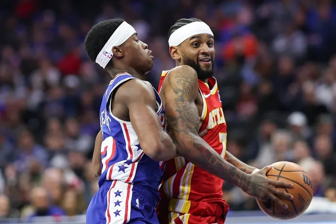 Feb 19, 2026; Philadelphia, Pennsylvania, USA; Atlanta Hawks guard Nickeil Alexander-Walker (7) drives against Philadelphia 76ers guard Vj Edgecombe (77) during the first quarter at Xfinity Mobile Arena.