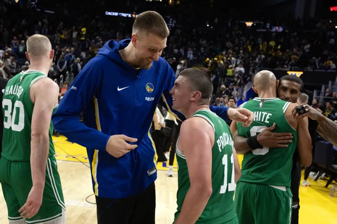 Feb 19, 2026; San Francisco, California, USA; Golden State Warriors center Kristaps Porzingis (left) shares a laugh with Boston Celtics guard Payton Pritchard (11) following their game at Chase Center. Mandatory Credit: D. Ross Cameron-Imagn Images