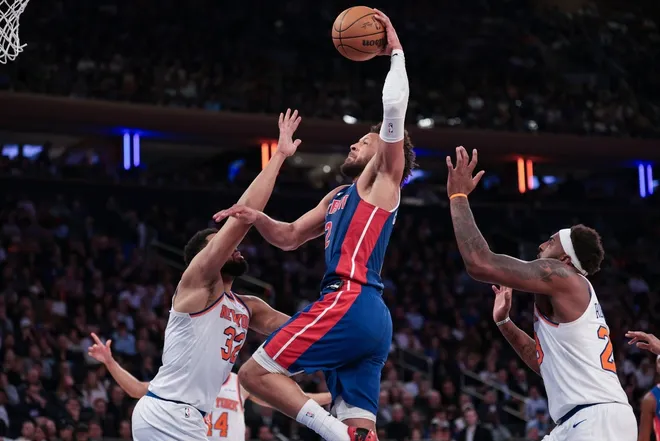 Feb 19, 2026; New York, New York, USA; Detroit Pistons guard Cade Cunningham (2) goes up for a dunk against New York Knicks center Karl-Anthony Towns (32) during the second half at Madison Square Garden.
