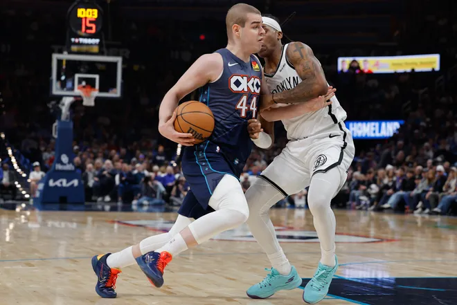 Feb 20, 2026; Oklahoma City, Oklahoma, USA; Oklahoma City Thunder guard Nikola Topić (44) drives past Brooklyn Nets guard/forward Terance Mann (14) during the second half at Paycom Center. Mandatory Credit: Alonzo Adams-Imagn Images