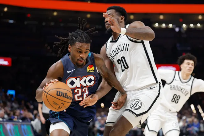 Feb 20, 2026; Oklahoma City, Oklahoma, USA; Oklahoma City Thunder guard Cason Wallace (22) drives past Brooklyn Nets center Day'ron Sharpe (20) during the second half at Paycom Center. Mandatory Credit: Alonzo Adams-Imagn Images