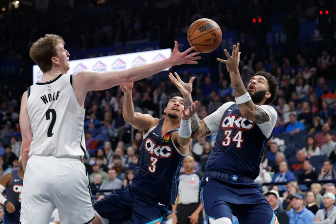Feb 20, 2026; Oklahoma City, Oklahoma, USA; Brooklyn Nets forward Danny Wolf (2), Oklahoma City Thunder guard Jared McCain (3) and guard Kenrich Williams (34) reach for a loose ball during the second half at Paycom Center. Mandatory Credit: Alonzo Adams-Imagn Images