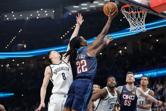 Feb 20, 2026; Oklahoma City, Oklahoma, USA; Oklahoma City Thunder guard Cason Wallace (22) shoots beside Brooklyn Nets guard Egor Dëmin (8) during the second half at Paycom Center. Mandatory Credit: Alonzo Adams-Imagn Images