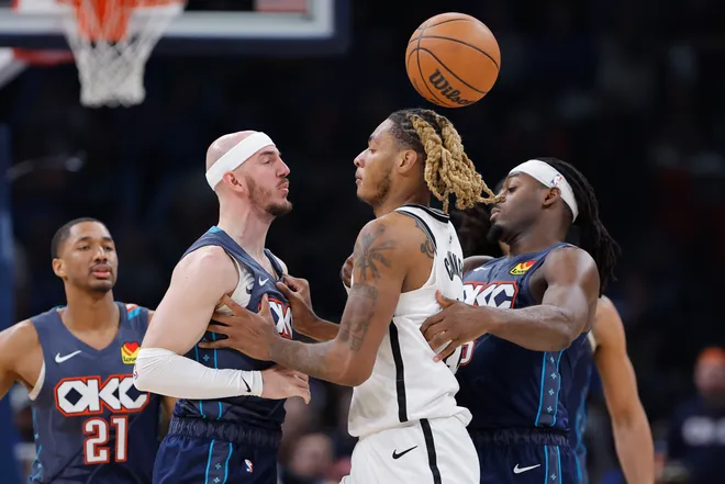 Feb 20, 2026; Oklahoma City, Oklahoma, USA; Oklahoma City Thunder guard Alex Caruso (9) and Brooklyn Nets forward/center Noah Clowney (21) get into an argument during the second half at Paycom Center. Mandatory Credit: Alonzo Adams-Imagn Images