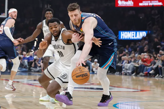 Feb 20, 2026; Oklahoma City, Oklahoma, USA; Brooklyn Nets center Day'ron Sharpe (20) and Oklahoma City Thunder center/forward Isaiah Hartenstein (55) reach for a loose ball during the first half at Paycom Center. Mandatory Credit: Alonzo Adams-Imagn Images