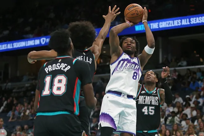 Feb 20, 2026; Memphis, Tennessee, USA; Utah Jazz guard Isaiah Collier (8) shoots against Memphis Grizzlies forward Jaylen Wells (0) during the fourth quarter at FedExForum.