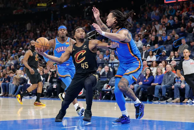 Feb 22, 2026; Oklahoma City, Oklahoma, USA; Cleveland Cavaliers guard Donovan Mitchell (45) drives to the basket as Oklahoma City Thunder forward Jaylin Williams (6) defends during the second half at Paycom Center. Mandatory Credit: Alonzo Adams-Imagn Images
