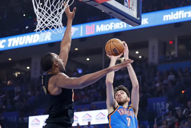 Feb 22, 2026; Oklahoma City, Oklahoma, USA; Oklahoma City Thunder center/forward Chet Holmgren (7) shoots as Cleveland Cavaliers center Evan Mobley (4) defends during the first quarter at Paycom Center. Mandatory Credit: Alonzo Adams-Imagn Images