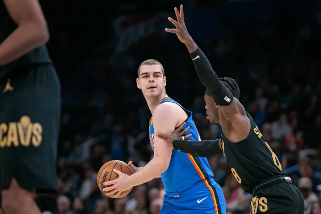 OKLAHOMA CITY, OKLAHOMA - FEBRUARY 22: Nikola Topic #44 of the Oklahoma City Thunder looks to pass around Dennis Schroder #8 of the Cleveland Cavaliers during the second half at Paycom Center on February 22, 2026 in Oklahoma City, Oklahoma. NOTE TO USER: User expressly acknowledges and agrees that, by downloading and or using this photograph, User is consenting to the terms and conditions of the Getty Images License Agreement. (Photo by William Purnell/Getty Images)