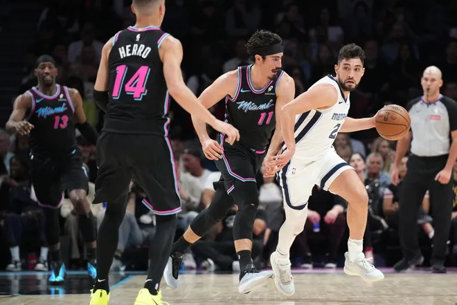 Feb 21, 2026; Miami, Florida, USA; Memphis Grizzlies guard Ty Jerome (2) drives up the court as Miami Heat forward Jaime Jaquez Jr. (11) defends during the first half at Kaseya Center.