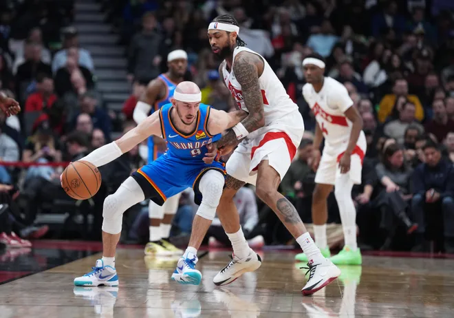 Feb 24, 2026; Toronto, Ontario, CAN; Oklahoma City Thunder guard Alex Caruso (9) dribbles against Toronto Raptors forward Brandon Ingram (3) during the second quarter at Scotiabank Arena. Mandatory Credit: Nick Turchiaro-Imagn Images