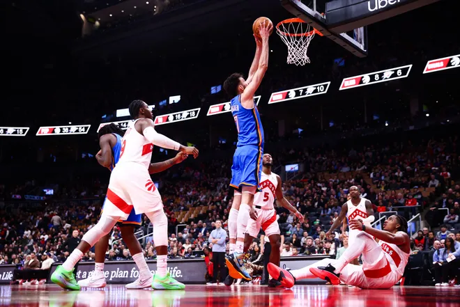 TORONTO, CANADA - FEBRUARY 24: Chet Holmgren #7 of the Oklahoma City Thunder dunks as Collin Murray-Boyles #12 of the Toronto Raptors looks up from the floor during the second half of their NBA game at Scotiabank Arena on February 24, 2026 in Toronto, Ontario, Canada. NOTE TO USER: User expressly acknowledges and agrees that, by downloading and or using this photograph, User is consenting to the terms and conditions of the Getty Images License Agreement. (Photo by Cole Burston/Getty Images)