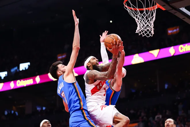 TORONTO, CANADA - FEBRUARY 24: Brandon Ingram #3 of the Toronto Raptors drives to the net against Chet Holmgren #7 and Alex Caruso #9 of the Oklahoma City Thunder during the first half of their NBA game at Scotiabank Arena on February 24, 2026 in Toronto, Ontario, Canada. NOTE TO USER: User expressly acknowledges and agrees that, by downloading and or using this photograph, User is consenting to the terms and conditions of the Getty Images License Agreement. (Photo by Cole Burston/Getty Images)