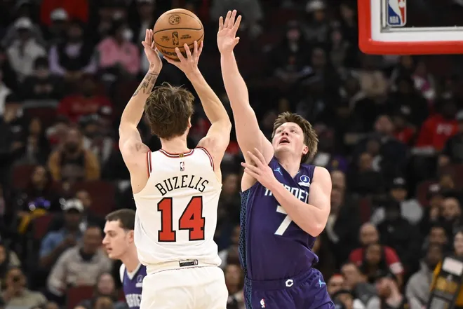 Feb 24, 2026; Chicago, Illinois, USA; Chicago Bulls forward Matas Buzelis (14) shoots against Charlotte Hornets guard Kon Knueppel (7) during the first half at United Center.