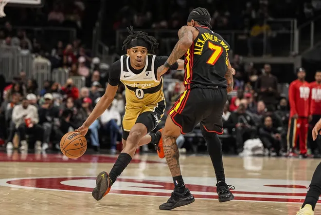 Feb 24, 2026; Atlanta, Georgia, USA; Washington Wizards guard Bilal Coulibaly (0) dribbles against Atlanta Hawks guard Nickeil Alexander-Walker (7) during the first half at State Farm Arena.
