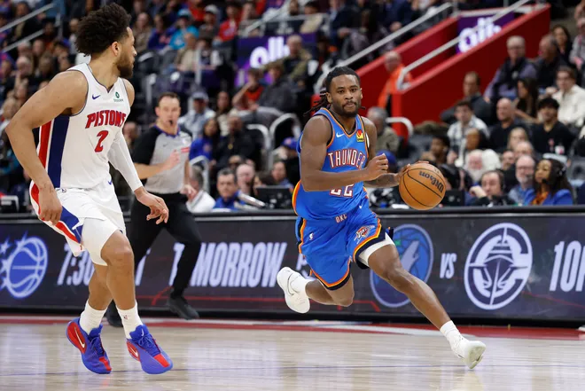 Feb 25, 2026; Detroit, Michigan, USA; Oklahoma City Thunder guard Cason Wallace (22) dribbles defended by Detroit Pistons guard Cade Cunningham (2) in the second half at Little Caesars Arena. Mandatory Credit: Rick Osentoski-Imagn Images