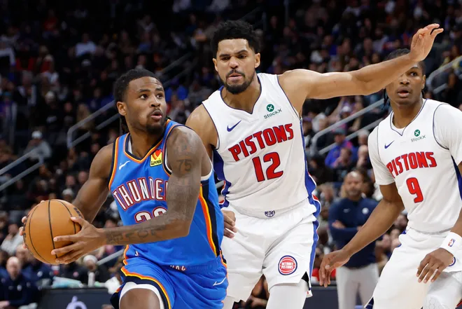Feb 25, 2026; Detroit, Michigan, USA; Oklahoma City Thunder guard Cason Wallace (22) dribbles defended by Detroit Pistons forward Tobias Harris (12) in the second half at Little Caesars Arena. Mandatory Credit: Rick Osentoski-Imagn Images
