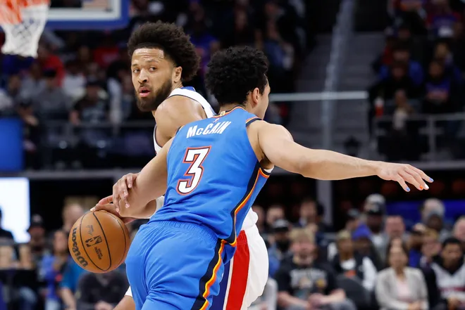 Feb 25, 2026; Detroit, Michigan, USA; Detroit Pistons center Isaac Jones (3) dribbles defended by Oklahoma City Thunder guard Jared McCain (3) in the first half at Little Caesars Arena. Mandatory Credit: Rick Osentoski-Imagn Images