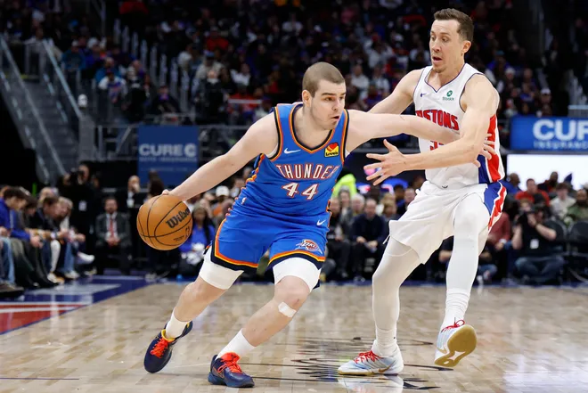 Feb 25, 2026; Detroit, Michigan, USA; Oklahoma City Thunder guard Nikola Topic (44) dribbles defended by Detroit Pistons forward Duncan Robinson (55) in the second half at Little Caesars Arena. Mandatory Credit: Rick Osentoski-Imagn Images