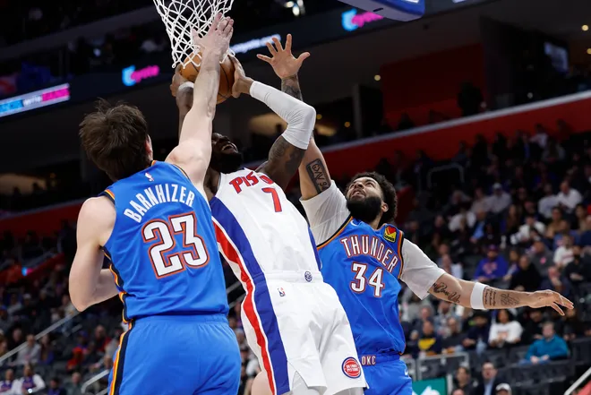Feb 25, 2026; Detroit, Michigan, USA; Detroit Pistons forward Paul Reed (7) shoots defended by Oklahoma City Thunder forward Brooks Barnhizer (23) and guard Kenrich Williams (34) in the first half at Little Caesars Arena. Mandatory Credit: Rick Osentoski-Imagn Images