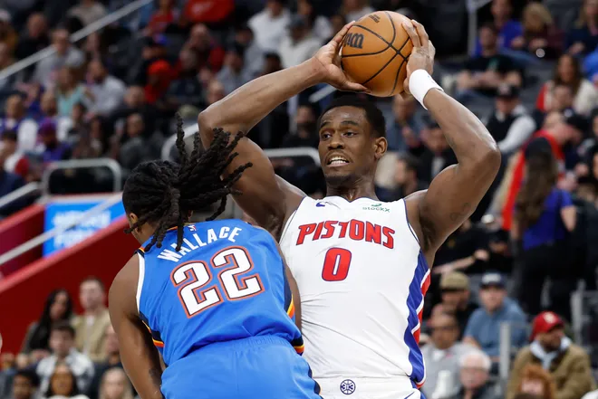 Feb 25, 2026; Detroit, Michigan, USA; Detroit Pistons center Jalen Duren (0) is defended by Oklahoma City Thunder guard Cason Wallace (22) in the first half at Little Caesars Arena. Mandatory Credit: Rick Osentoski-Imagn Images