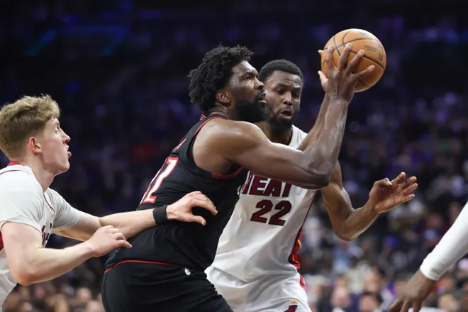 Feb 26, 2026; Philadelphia, Pennsylvania, USA; Philadelphia 76ers center Joel Embiid (21) drives for a shot against Miami Heat forward Andrew Wiggins (22) during the fourth quarter at Xfinity Mobile Arena. Mandatory Credit: Bill Streicher-Imagn Images