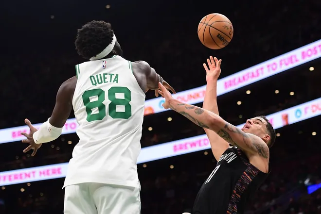 Feb 27, 2026; Boston, Massachusetts, USA; Brooklyn Nets forward Michael Porter Jr. (17) shoots the ball while Boston Celtics center Neemias Queta (88) defends during the first half at TD Garden.